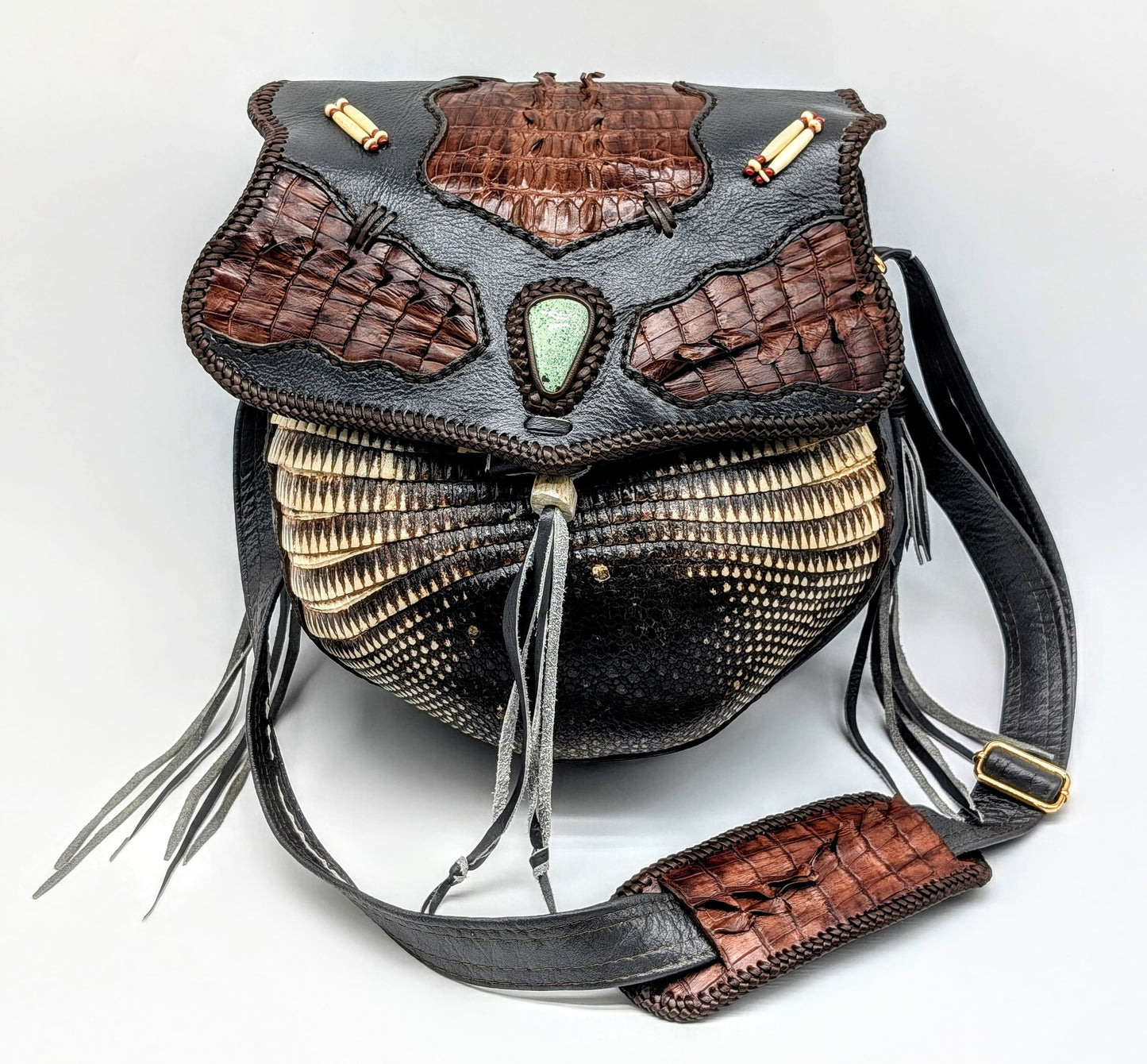 Decorative handbag with intricate design on a white background